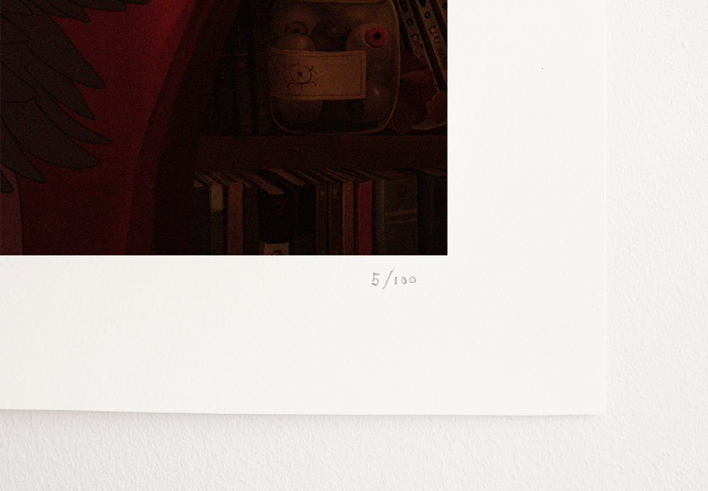 A close-up of the bottom-right corner of the Halloween-themed print, showing the print number "5/100" hand-signed on the white border. A shelf with books and jars in the background adds detail to the magical room illustrated.