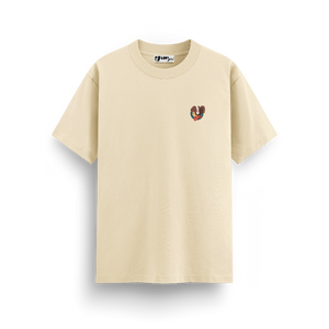 
                  
                    Beige t-shirt with a small graphic on a white background
                  
                