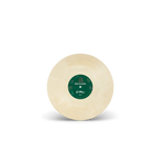 Round beige object with a green label on a white background