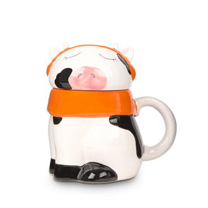 
                  
                    Ceramic mug shaped like a cow with an orange lid on a white background
                  
                