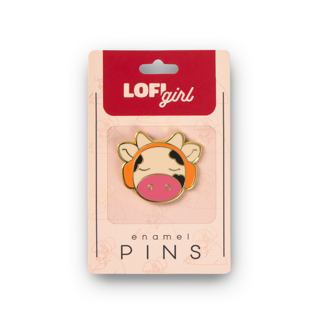 Enamel pin with cow design on LOFI girl branded packaging