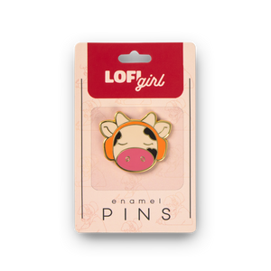 
                  
                    Enamel pin with cow design on LOFI girl branded packaging
                  
                