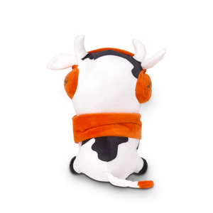 
                  
                    Plush toy cow with orange outfit and black spots on a white background
                  
                