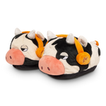 Pair of cow-themed slippers with orange bells on a white background