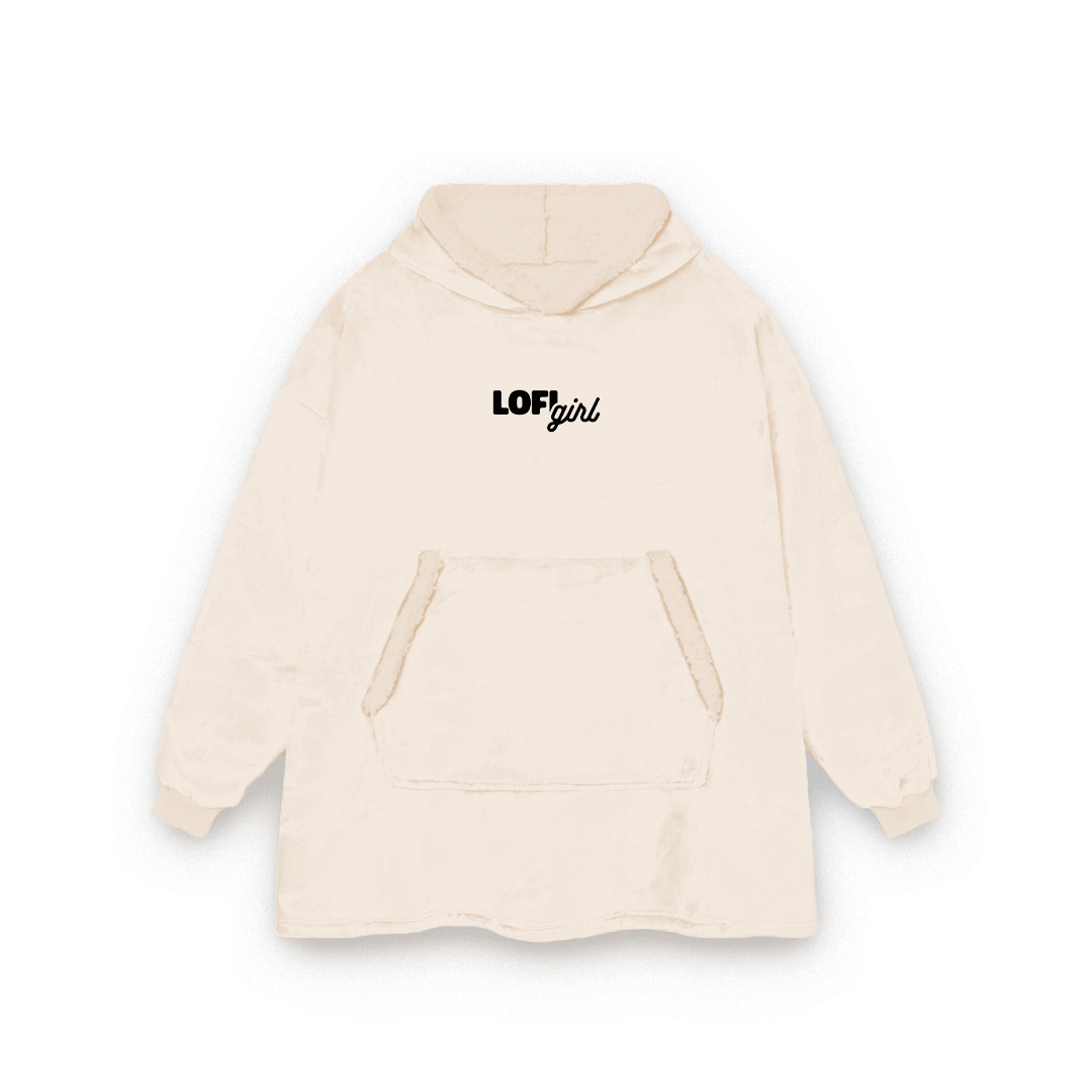 Lofi Girl Blanket Hoodie in beige, oversized wearable blanket with a black embroidered Lofi Girl logo on the chest and a big front pocket
