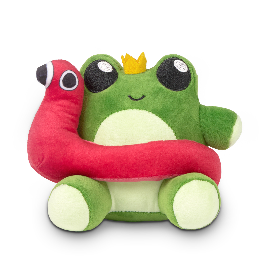 Plush toy frog with a crown holding a red worm on a white background