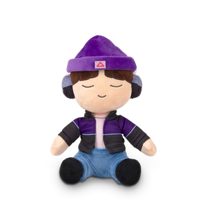 
                  
                    Plush toy with a purple outfit and hat on a white background
                  
                