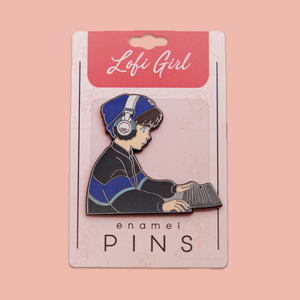 
                  
                    An adorable enamel pin featuring a Lofi Boy, sitting at his desk with headphones on, deeply immersed in his studies. The background showcases a cozy room with warm lighting, capturing the essence of relaxation and focus. Perfect for adding a touch of chill vibes to your backpack, jacket, or pin board.
                  
                