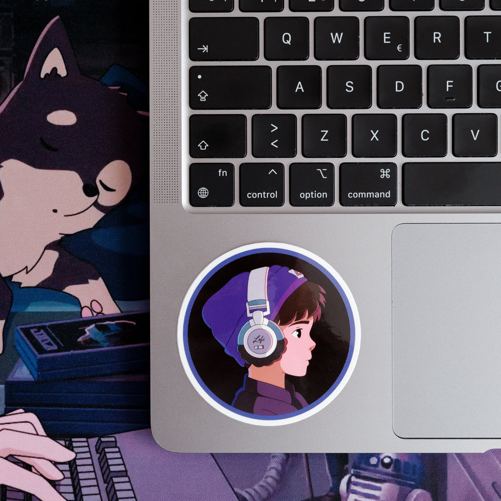 
                  
                    Round sticker featuring Lofi Boy with headphones, placed on a laptop keyboard.
                  
                