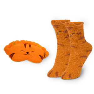 
                  
                    Pair of orange cat-themed socks and matching eye mask on a white background
                  
                