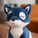 The image shows a close-up of a plush toy modeled after the "Lofi Dog." The plush has a soft blue and white color scheme, with a calm, sleeping expression that adds to its adorable and tranquil appearance. The dog's closed eyes and serene face capture the relaxed and chill aesthetic commonly associated with the Lofi brand. The soft material and detailed stitching around the eyes and ears give it a cozy and huggable feel, making it a perfect companion for creating a calming atmosphere, much like the Lofi Gir