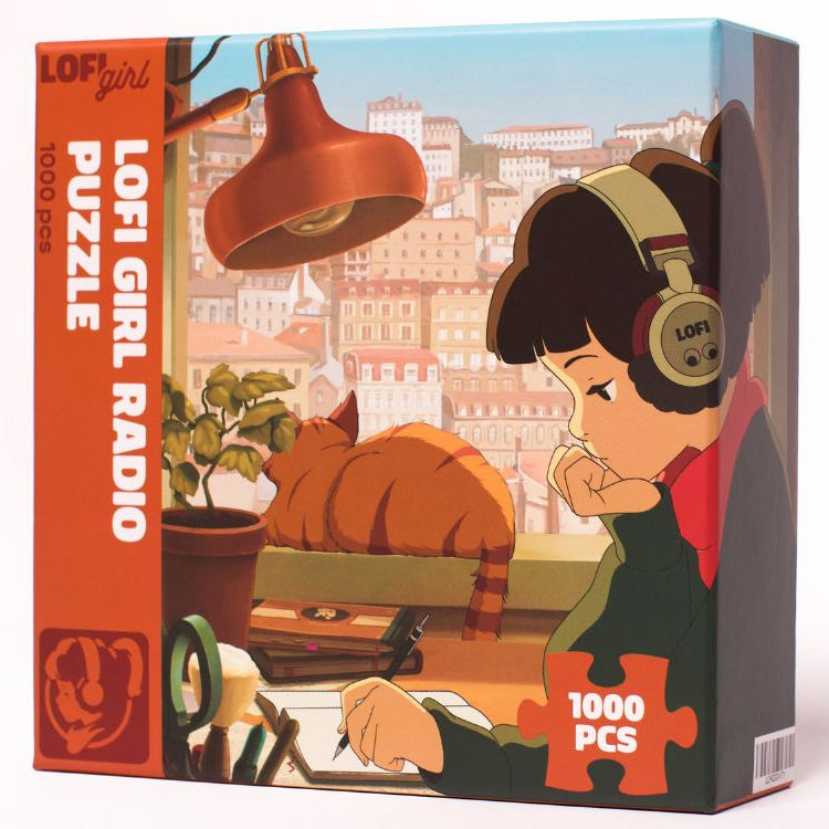 
                  
                    Front view of the Lofi Girl Radio Puzzle box, highlighting the detailed artwork of Lofi Girl wearing headphones, studying near a window with a sleeping cat in the background.
                  
                