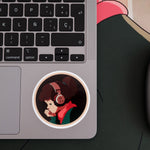 Sticker of Lofi Girl wearing headphones placed on a laptop near the keyboard.