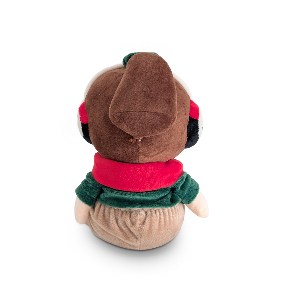
                  
                    Plush toy with a brown head, red scarf, and green sweater on a white background
                  
                