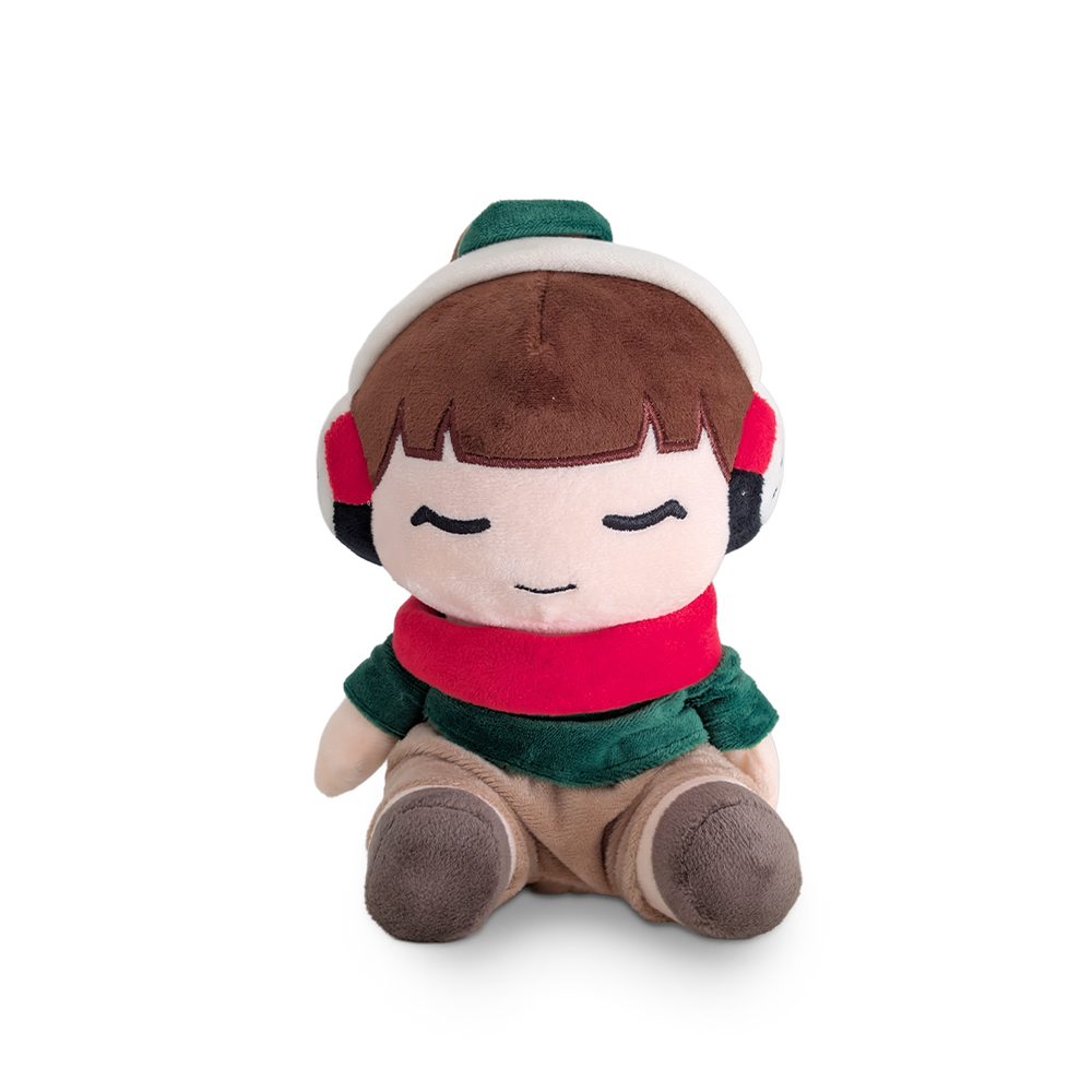 Plush toy of a character wearing a red scarf, green hat, and brown pants on a white background