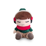 Plush toy of a character wearing a red scarf, green hat, and brown pants on a white background