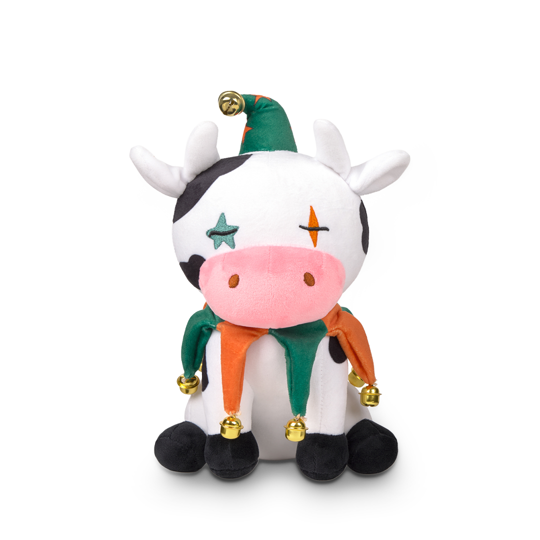 Plush toy cow with colorful accents on a white background