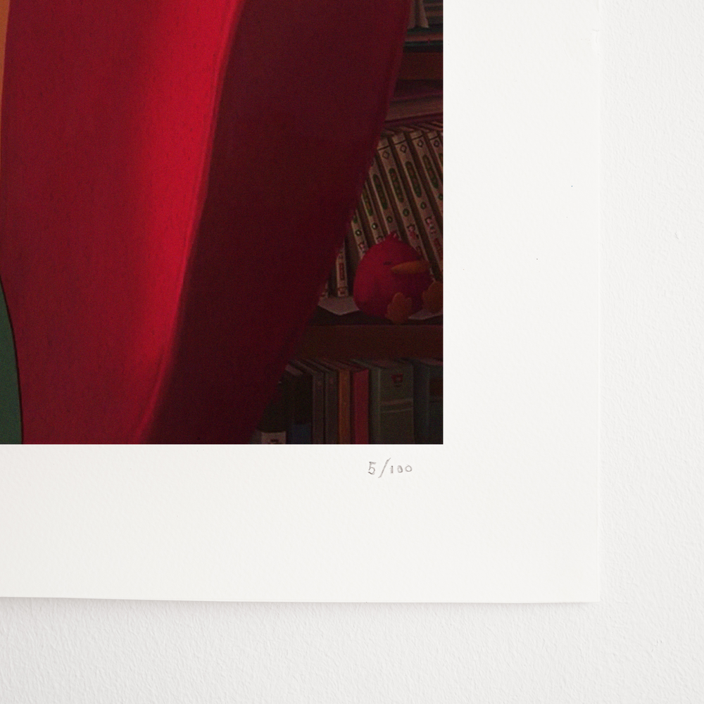 
                  
                    A close-up of the lower-right corner of a Lofi Girl print, showing the red back of a chair and bookshelves. The print is numbered '5/100' in pencil.
                  
                