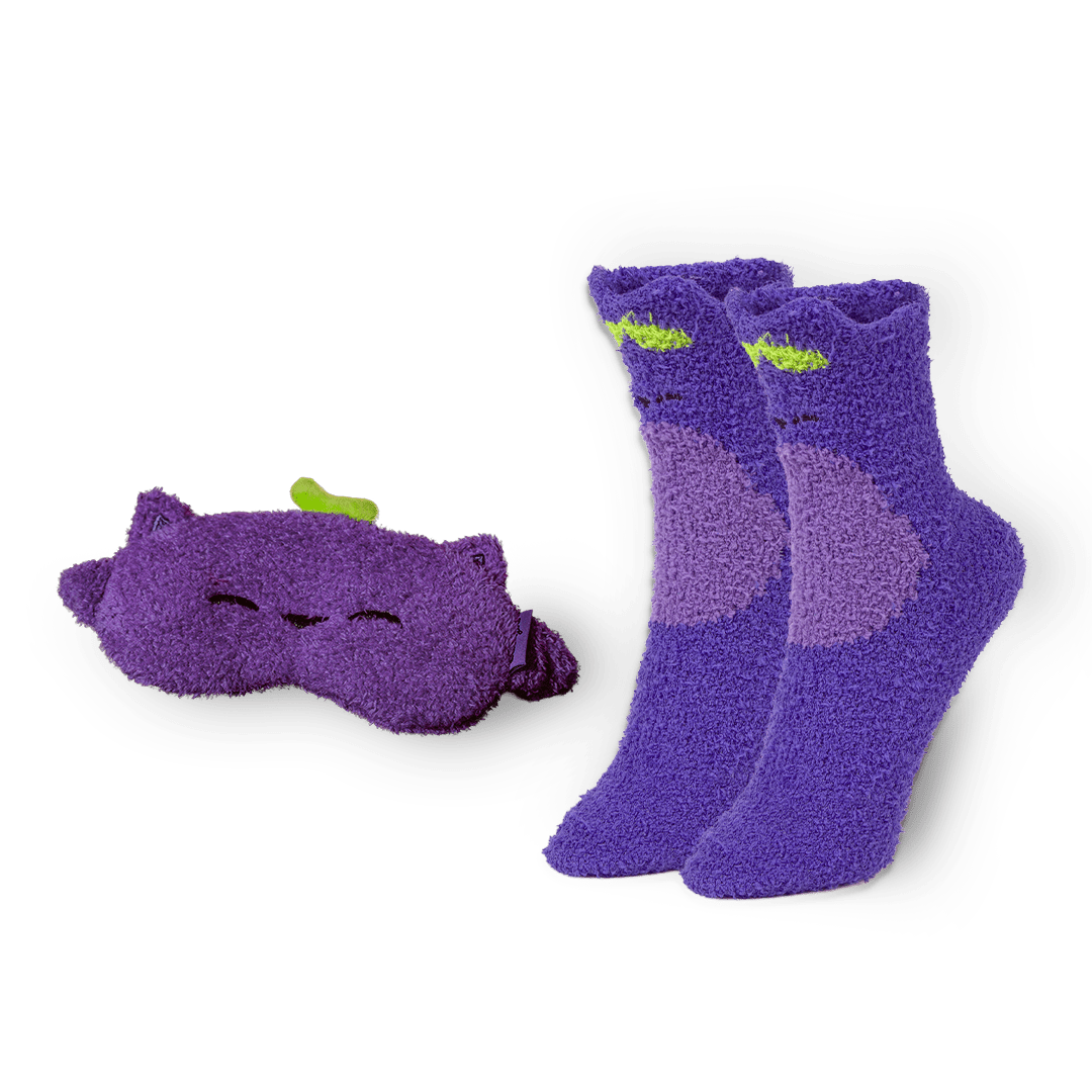 Pair of purple socks with a matching eye mask on a white background