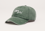 A side view of the vintage green cap, showing its curved brim and embroidered "Lofi girl" logo on the front. The cap's slightly faded and worn look gives it a classic vintage style.