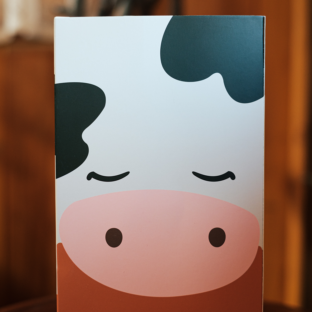 
                  
                    The minimalist design on the back of the Chilled Cow’s packaging matches the plushie’s serene vibe, featuring its cute, sleepy face. It’s a delightful reminder of the simplicity and joy of relaxation.
                  
                