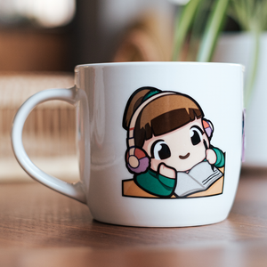 
                  
                    A white ceramic mug with a design of the Lofi Girl in a green sweater and headphones, resting her chin on her hand while reading a book. The mug is set on a wooden table.
                  
                